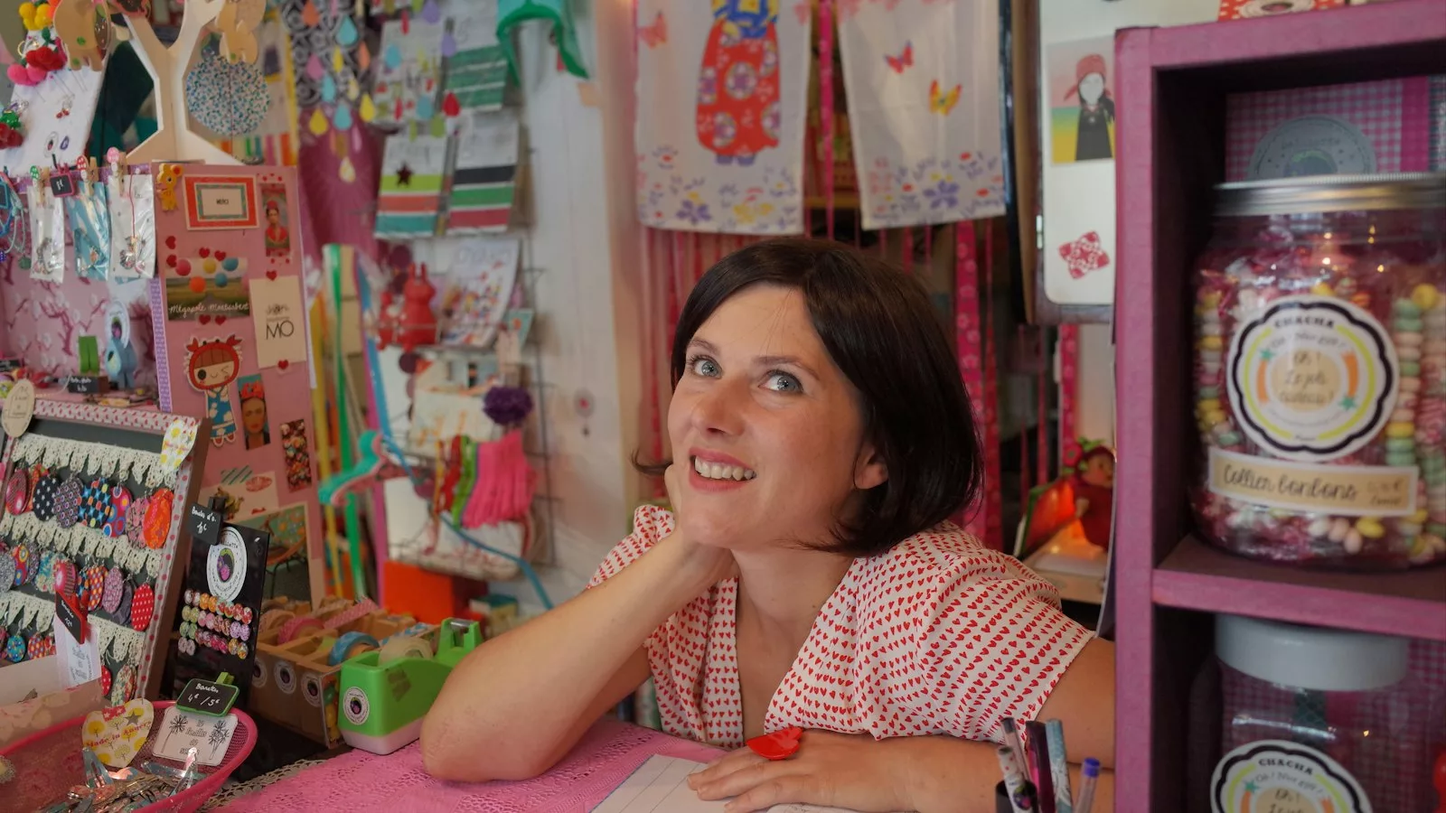 Dona recolzada en escriptori rosa